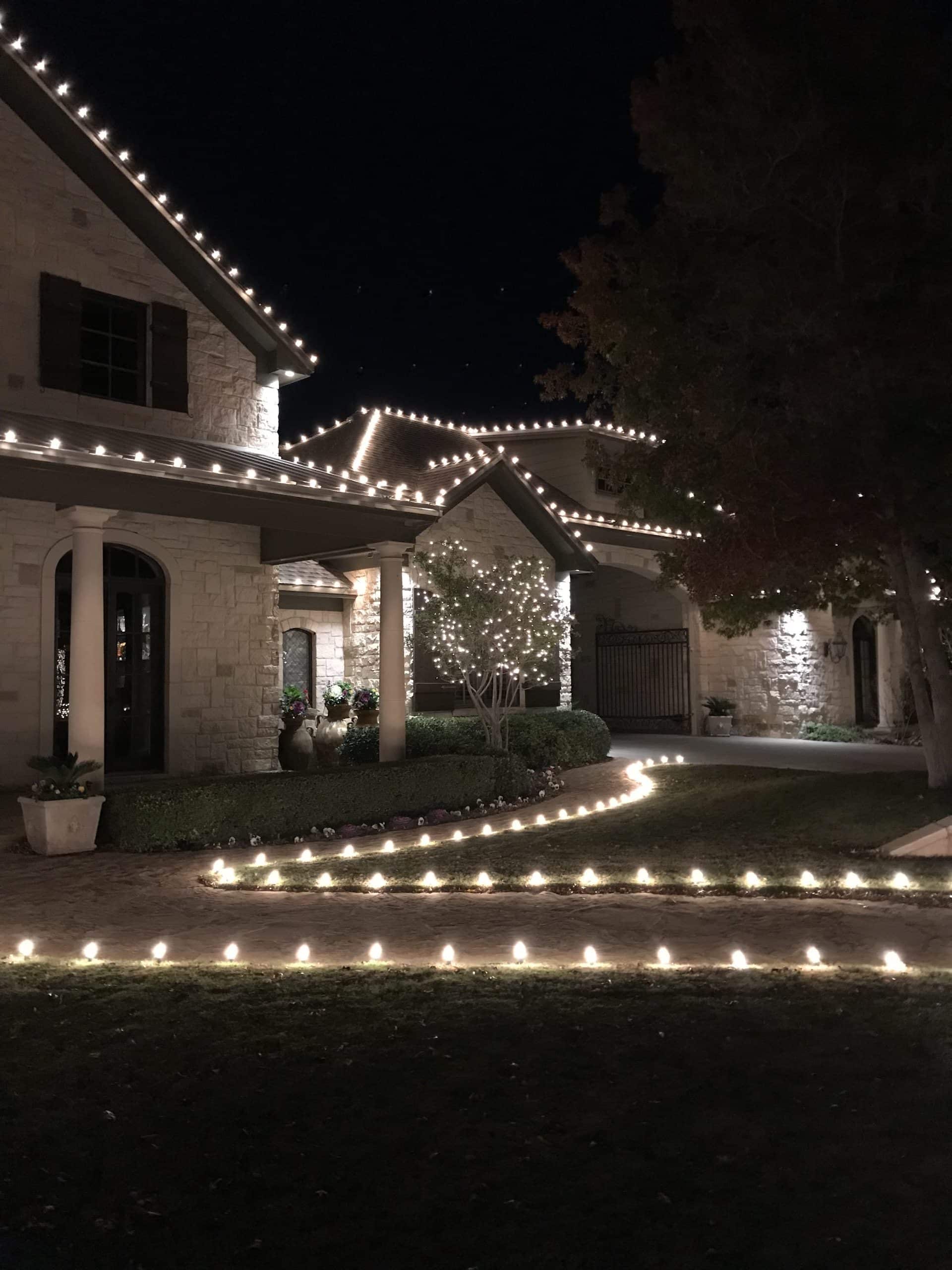 white lights lining exterior of a house