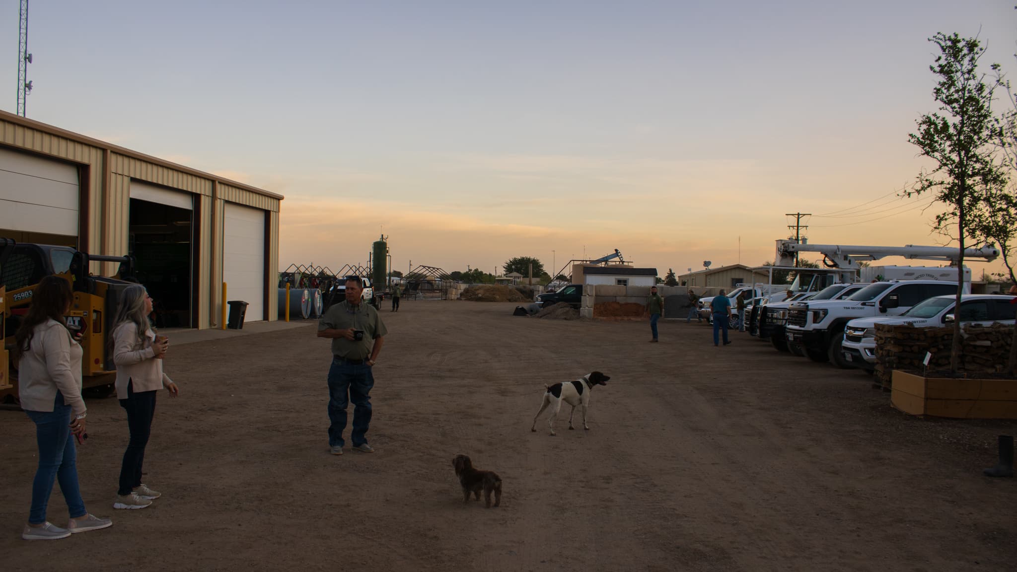 group of people outside with two dogs